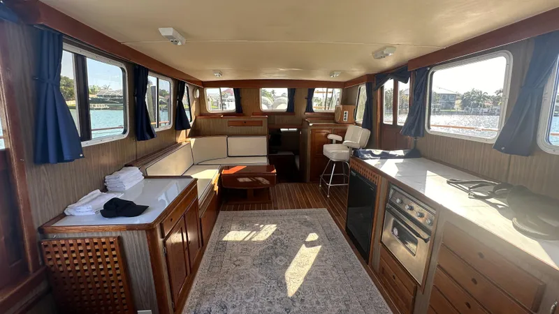 Slide: The Image of Interior of 1972 Bristol 42 Offshore Trawler with cozy seating and wooden cabinetry. - 7