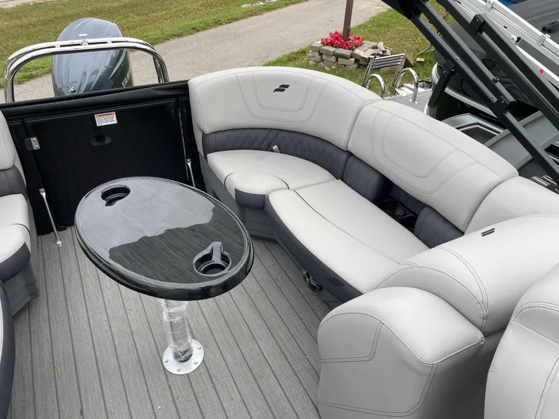 Slide: The Image of 2024 Starcraft SLS 5 boat interior with gray seating and sleek black table. - 13