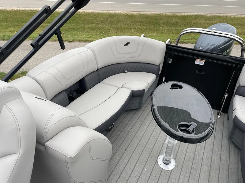 Slide: The Image of 2024 Starcraft SLS 5 boat interior with gray seating and a sleek black table. - 14