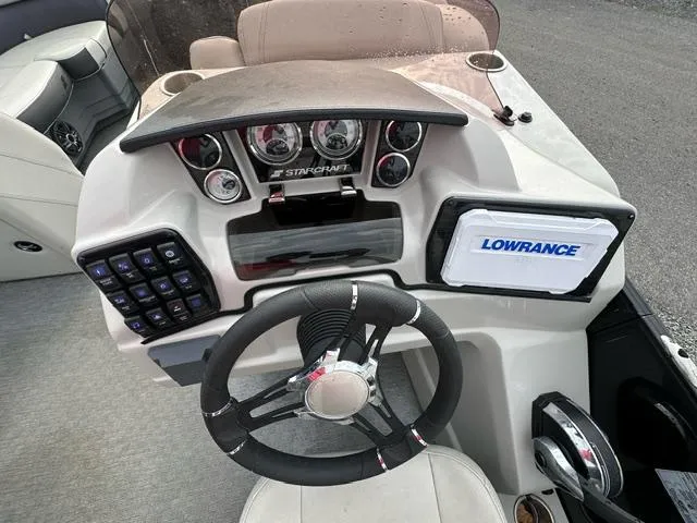 Slide: The Image of 2021 Starcraft SLS 1 boat dashboard with steering wheel and Lowrance navigation system. - 6