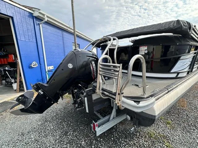 Slide: The Image of 2021 Starcraft SLS 1 boat with Mercury outboard motor near blue building. - 8