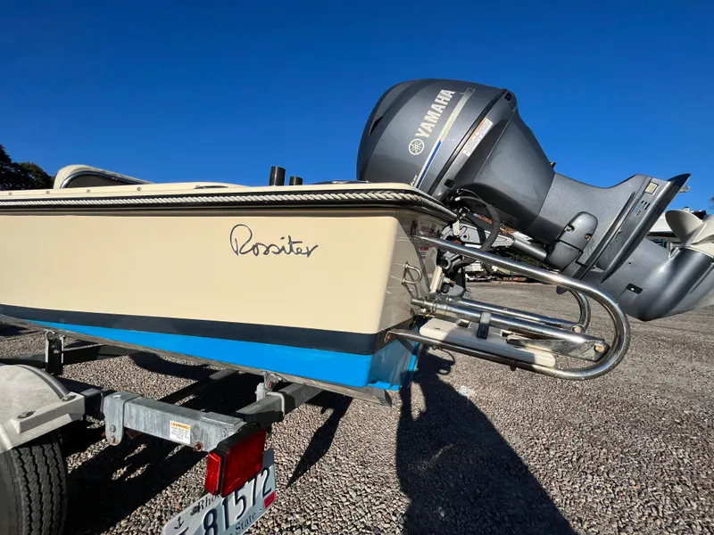 Slide: The Image of 2016 Rossiter Shoreline 14 boat with Yamaha motor on trailer, clear blue sky background. - 10