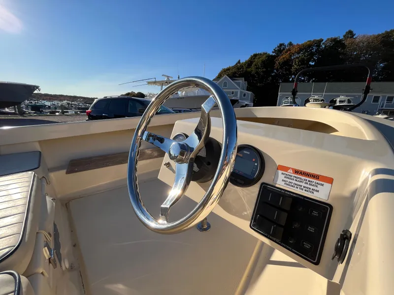 Slide: The Image of 2016 Rossiter Shoreline 14 boat dashboard with steering wheel and controls. - 12