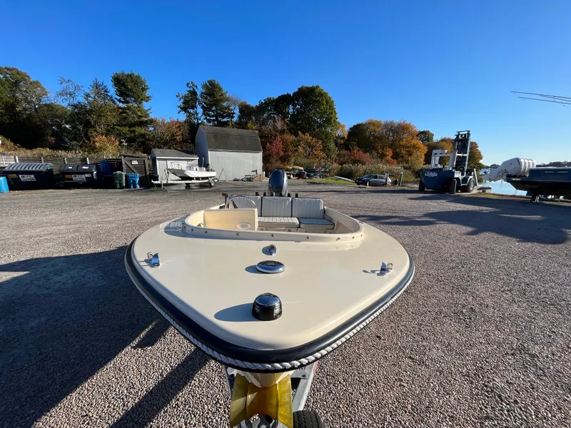 Slide: The Image of 2016 Rossiter Shoreline 14 boat on gravel lot under clear blue sky. - 14