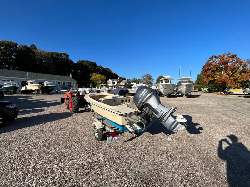 Slide: The Image of 2016 Rossiter Shoreline 14 boat on trailer in sunny outdoor lot. - 2