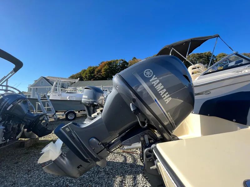 Slide: The Image of 2016 Rossiter Shoreline 14 with Yamaha outboard motor, parked on gravel lot. - 20