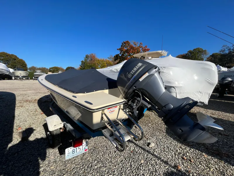 Slide: The Image of 2016 Rossiter Shoreline 14 boat with Yamaha motor on trailer, parked outdoors. - 21