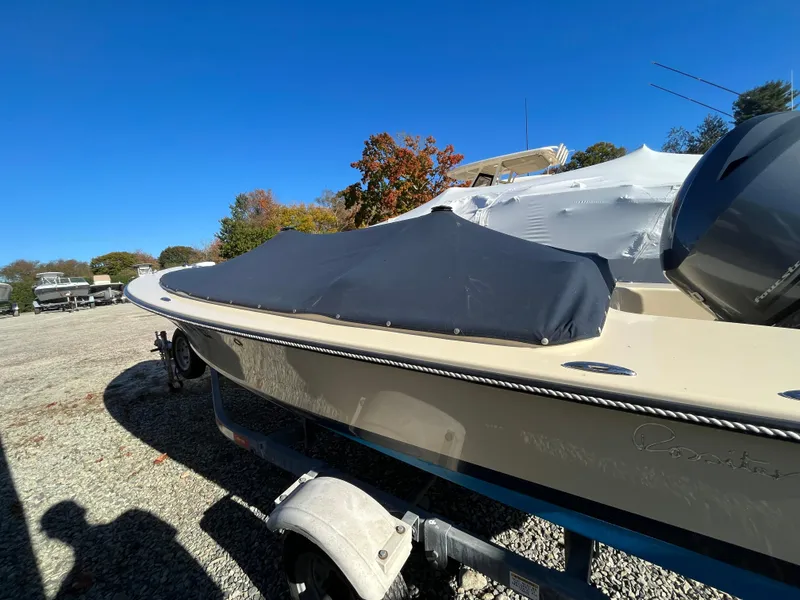 Slide: The Image of 2016 Rossiter Shoreline 14 boat with cover on trailer, outdoors. - 22