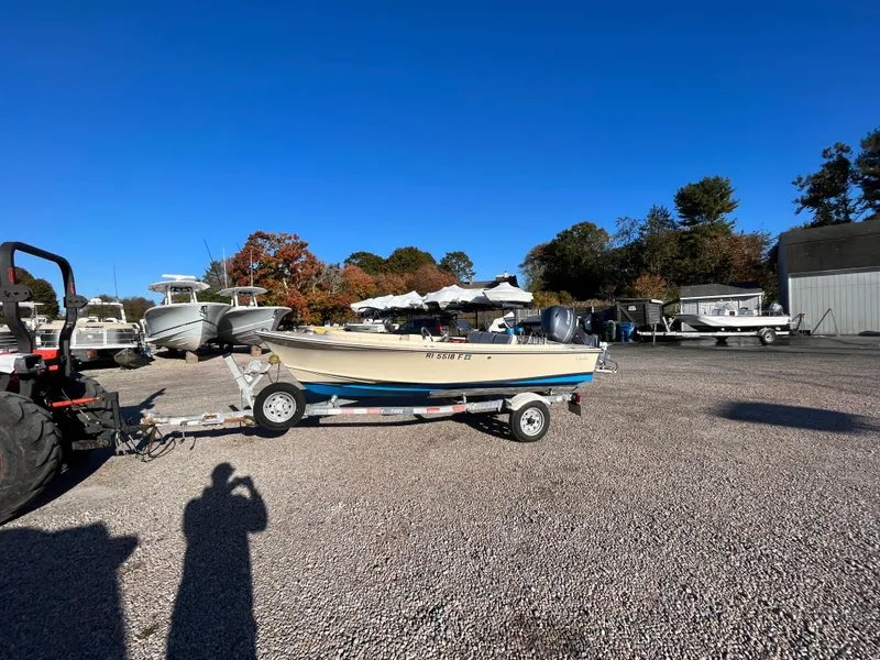 Slide: The Image of 2016 Rossiter Shoreline 14 boat on trailer in sunny outdoor lot. - 23