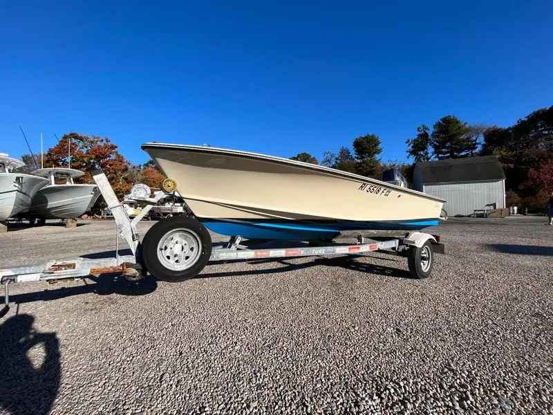 Slide: The Image of 2016 Rossiter Shoreline 14 boat on trailer in sunny outdoor setting. - 24
