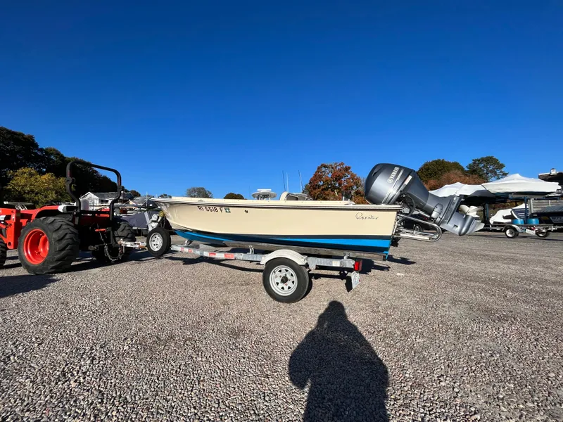 Slide: The Image of 2016 Rossiter Shoreline 14 boat on trailer, parked on gravel lot. - 26