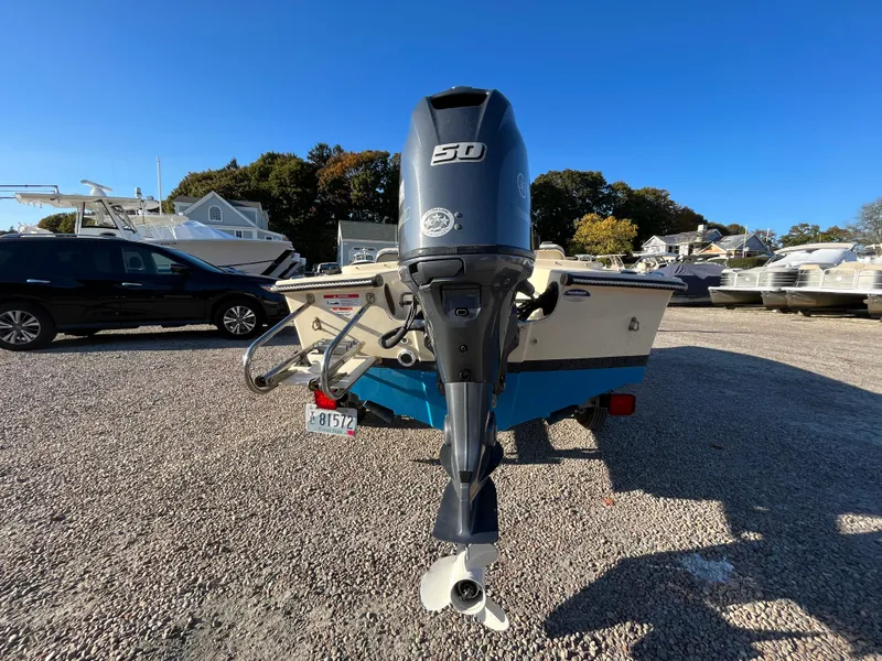 Slide: The Image of 2016 Rossiter Shoreline 14 boat with 50 HP outboard motor in a gravel lot. - 5
