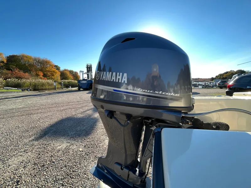Slide: The Image of Yamaha outboard motor on 2016 Rossiter Shoreline 14 boat, sunny day, autumn trees in background. - 6