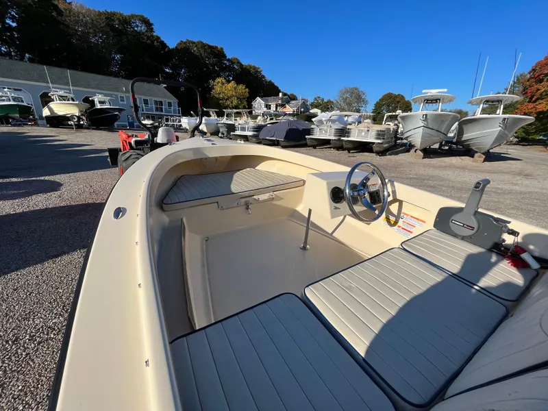 Slide: The Image of 2016 Rossiter Shoreline 14 boat interior with steering wheel, parked outdoors. - 9