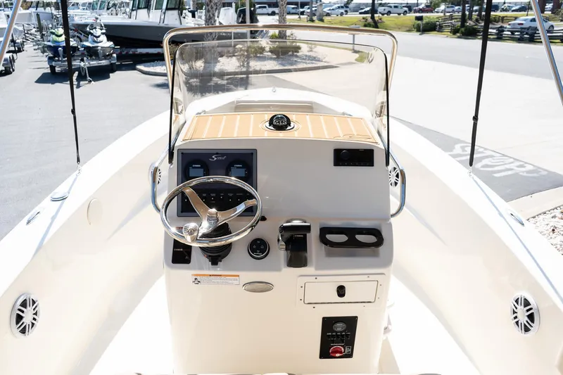 Slide: The Image of 2025 Scout 195 Sportfish boat console with steering wheel and controls. - 11