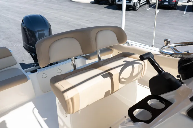 Slide: The Image of 2025 Scout 195 Sportfish boat interior with beige seating and steering console. - 12