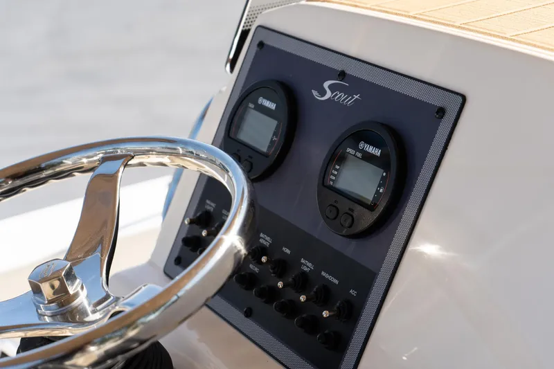 Slide: The Image of 2025 Scout 195 Sportfish dashboard with steering wheel and Yamaha gauges. - 13