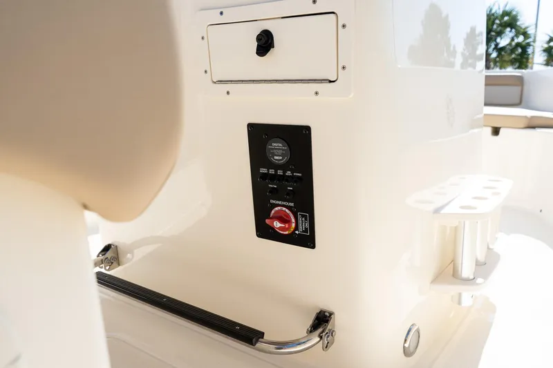 Slide: The Image of 2025 Scout 195 Sportfish boat interior with control panel and storage compartment. - 14