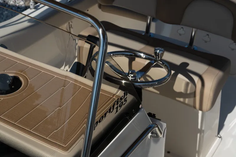 Slide: The Image of 2025 Scout 195 Sportfish boat interior with steering wheel and seating. - 18