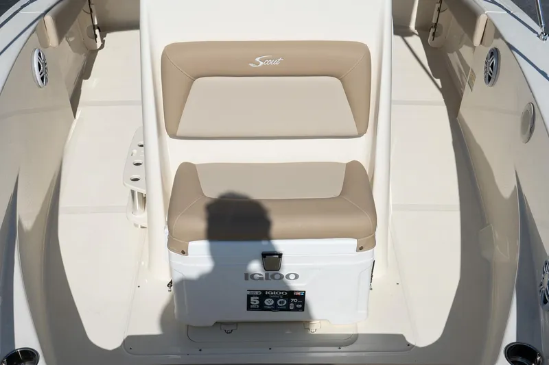 Slide: The Image of 2025 Scout 195 Sportfish boat seat with Igloo cooler, beige and white design. - 19