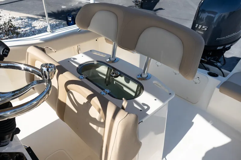 Slide: The Image of 2025 Scout 195 Sportfish boat interior with steering wheel and seating. - 21