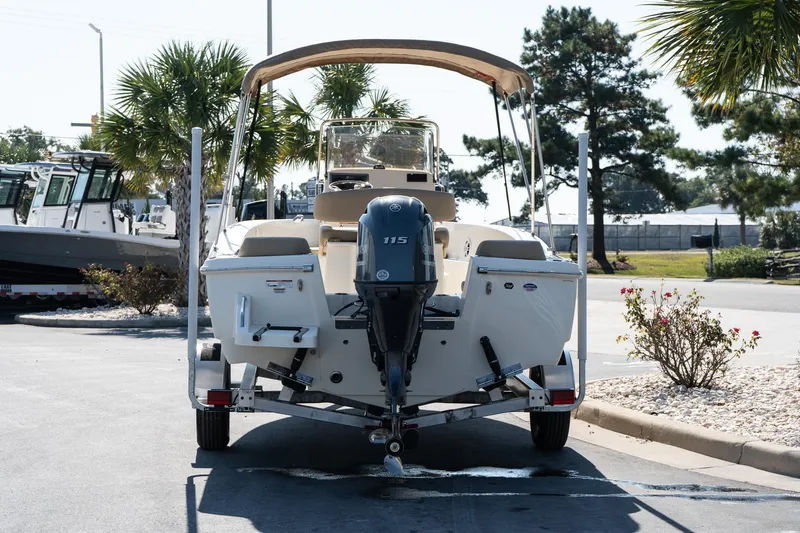 Slide: The Image of 2025 Scout 195 Sportfish boat on trailer, parked outdoors. - 4
