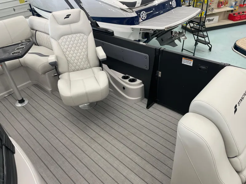 Slide: The Image of Luxurious interior of 2025 Starcraft RX 25 Q DC boat with plush seating. - 11