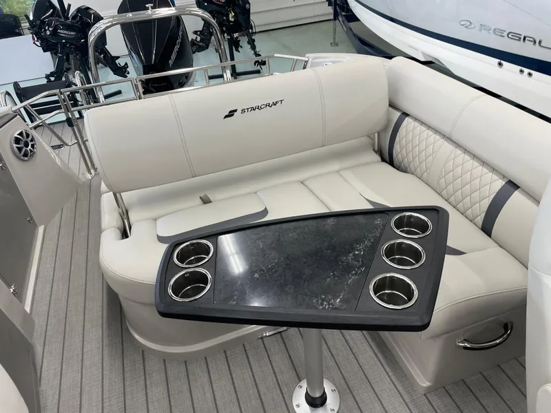 Slide: The Image of Luxurious seating area on 2025 Starcraft RX 25 Q DC boat with cupholders. - 14