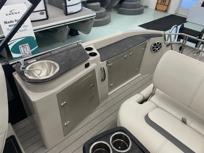 Slide: The Image of Starcraft RX 25 Q DC 2025 boat interior with sink and seating area. - 15