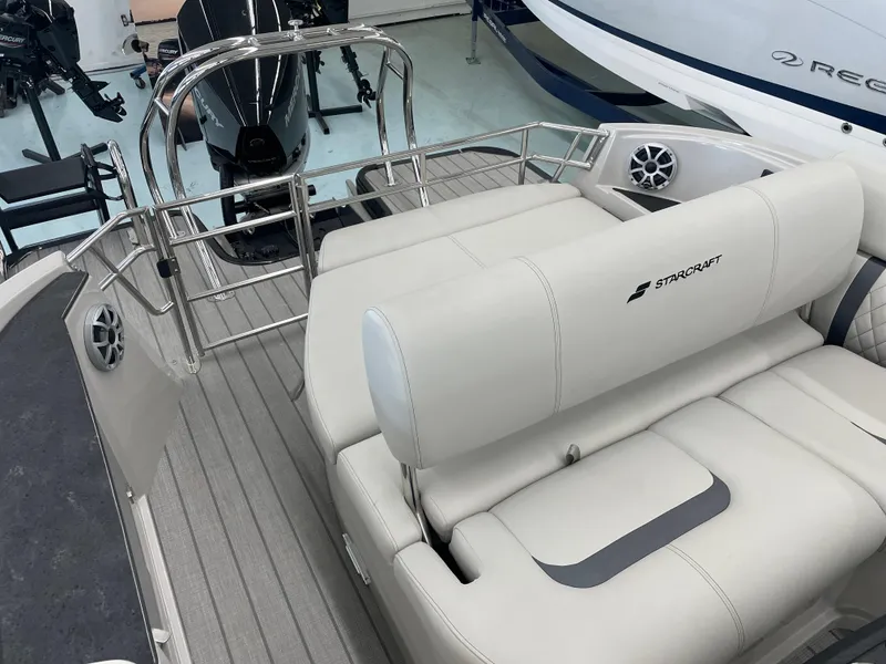 Slide: The Image of 2025 Starcraft RX 25 Q DC boat interior with plush seating and sleek design. - 16
