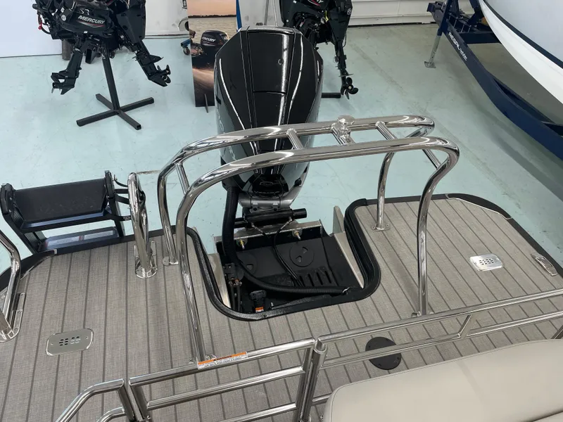 Slide: The Image of 2025 Starcraft RX 25 Q DC boat with outboard motor and stainless steel railing. - 18