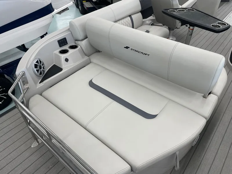 Slide: The Image of Luxurious seating on 2025 Starcraft RX 25 Q DC boat with cup holders and speaker. - 19