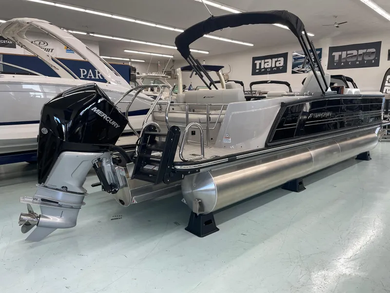 Slide: The Image of 2025 Starcraft RX 25 Q DC pontoon boat with Mercury outboard in showroom. - 3