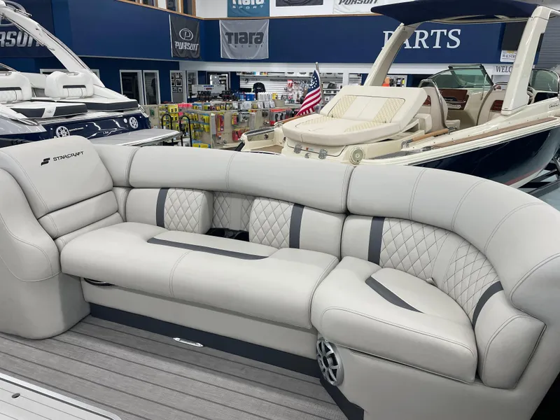 Slide: The Image of Luxurious seating on 2025 Starcraft RX 25 Q DC boat in showroom. - 9