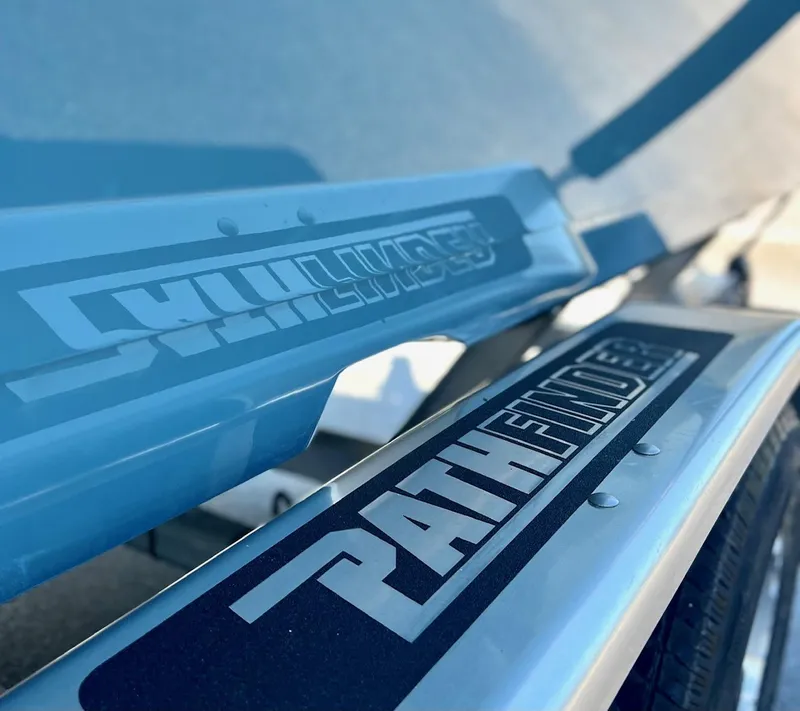 Slide: The Image of Close-up of 2025 Pathfinder 2600 TRS boat logo on blue surface. - 10