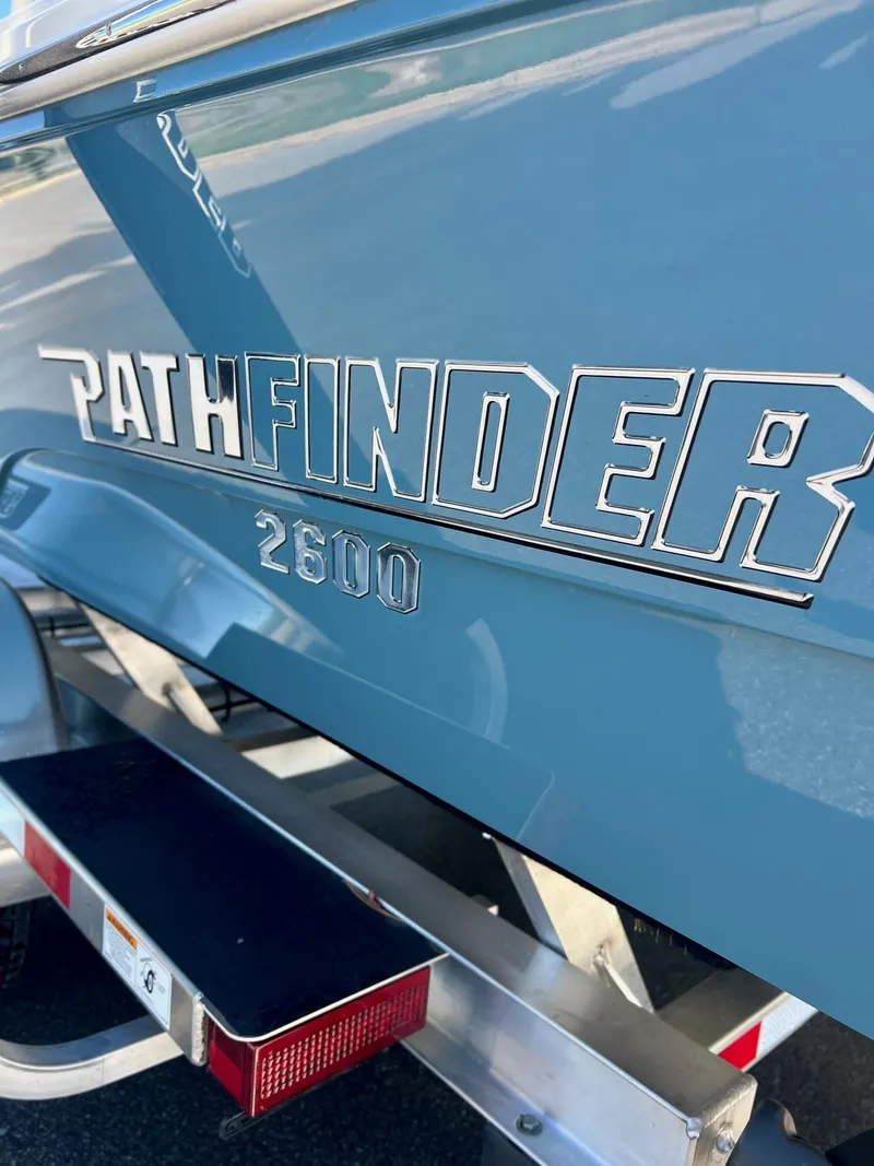 Slide: The Image of 2025 Pathfinder 2600 TRS boat logo on blue hull. - 11