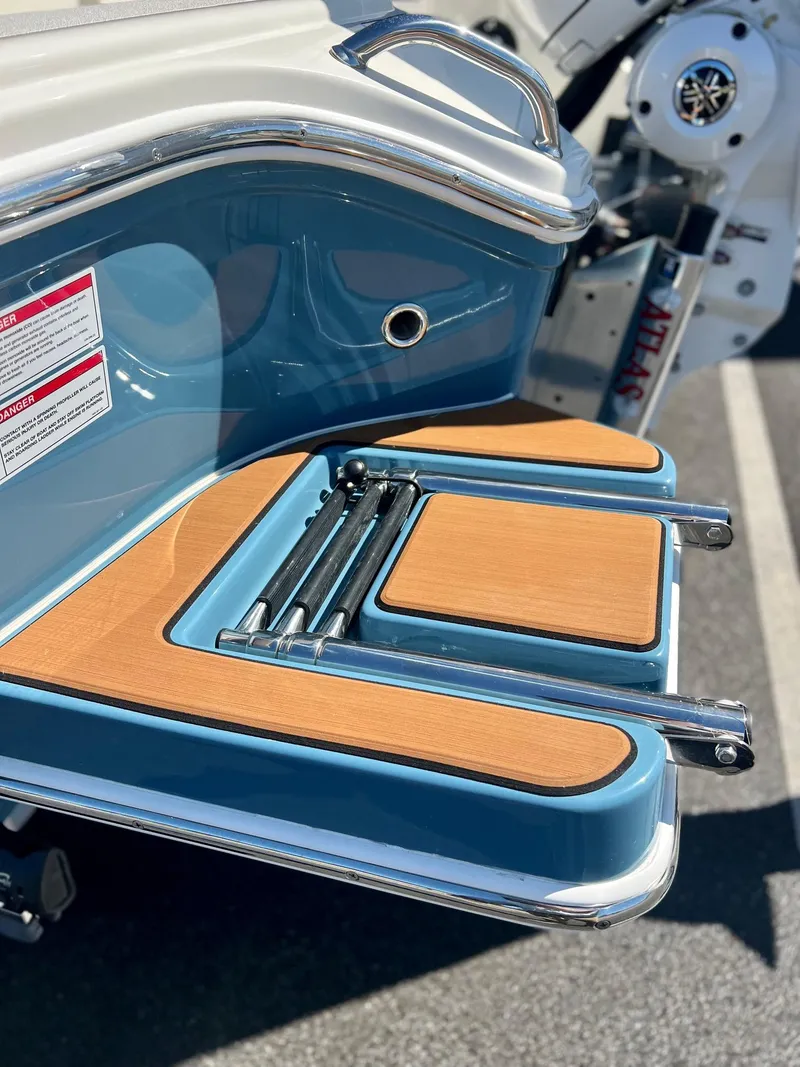 Slide: The Image of 2025 Pathfinder 2600 TRS boat with sleek blue and wood-accented swim platform. - 12