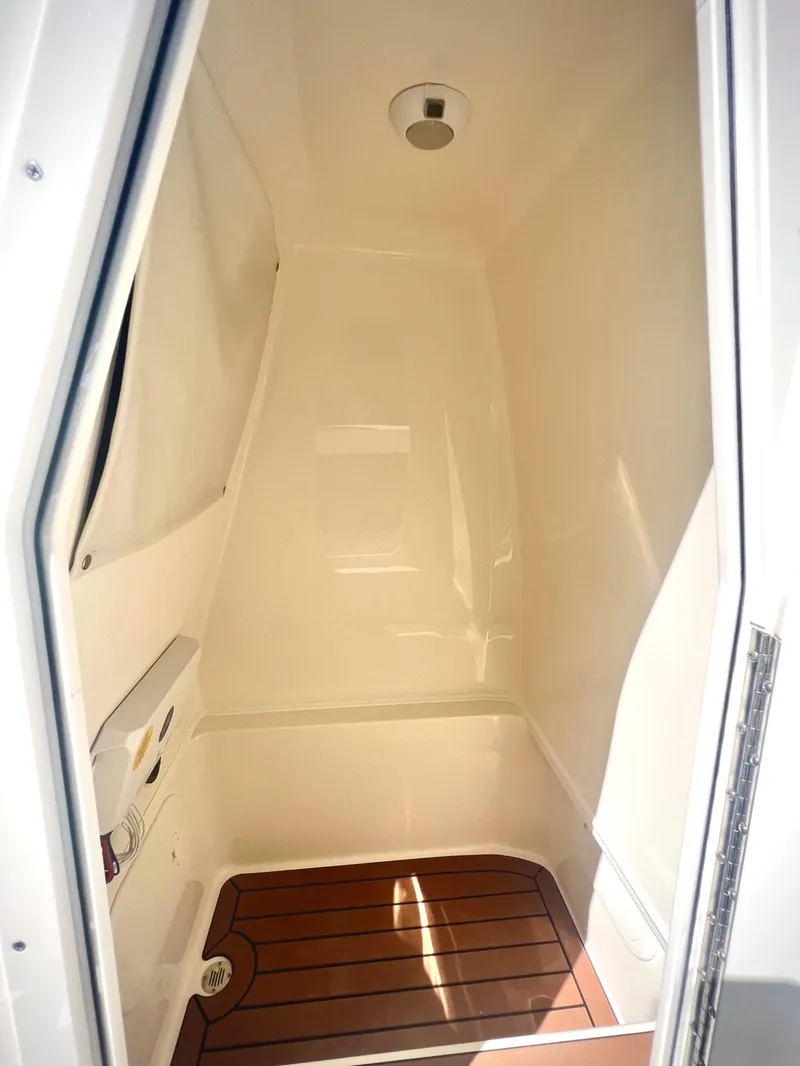 Slide: The Image of 2025 Pathfinder 2600 TRS boat interior cabin with wooden flooring. - 13
