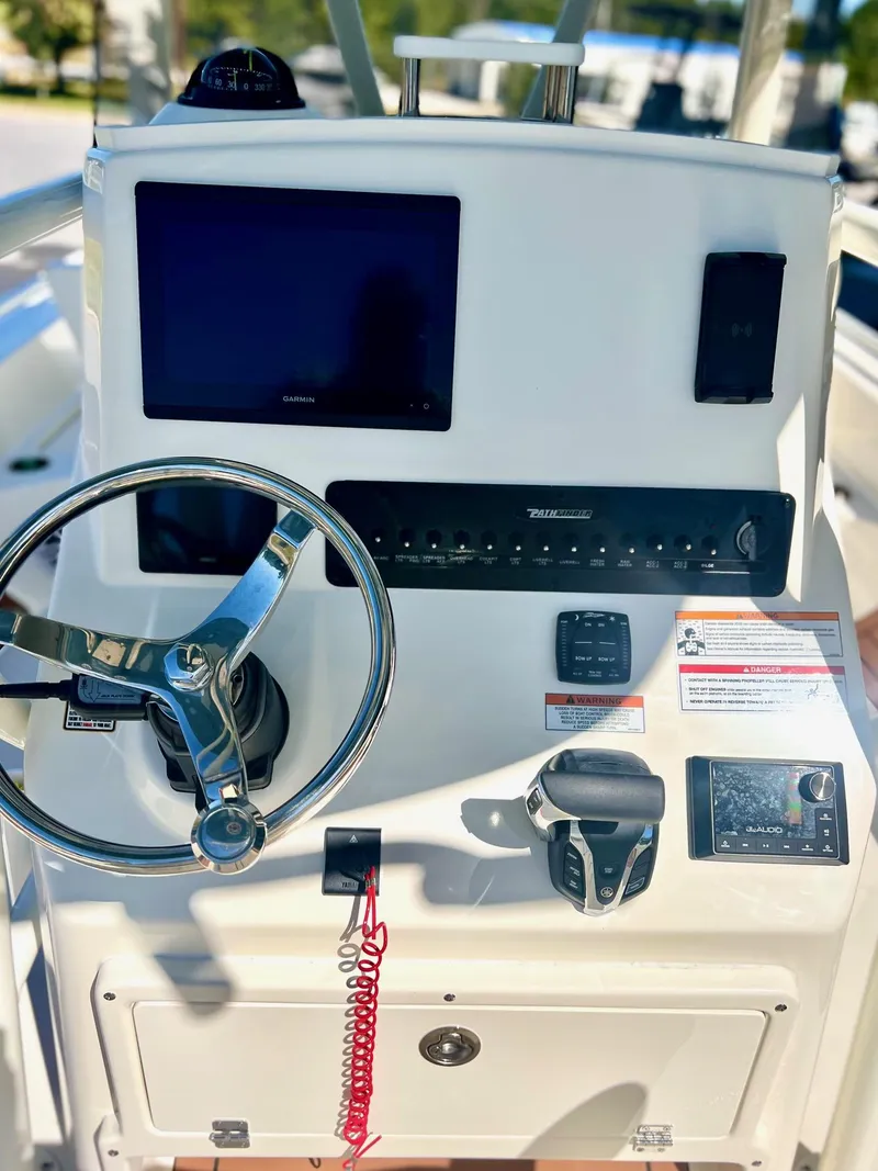 Slide: The Image of 2025 Pathfinder 2600 TRS boat dashboard with steering wheel and electronic controls. - 5