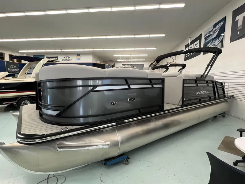 Slide: The Image of 2023 Starcraft CX 25 DL BAR pontoon boat in showroom, sleek design, modern features. - 1