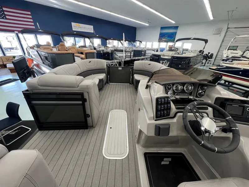 Slide: The Image of 2023 Starcraft CX 25 DL BAR pontoon boat interior with modern dashboard and seating. - 10