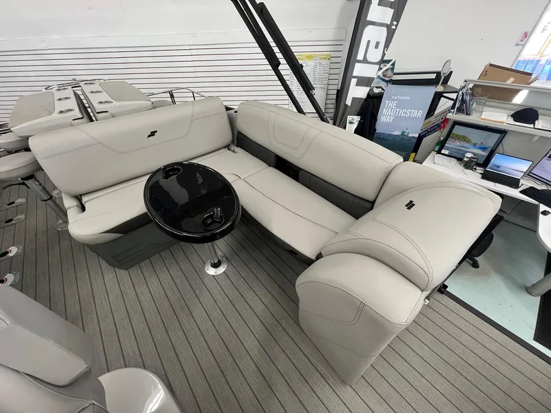 Slide: The Image of 2023 Starcraft CX 25 DL BAR boat interior with plush seating and sleek black table. - 11