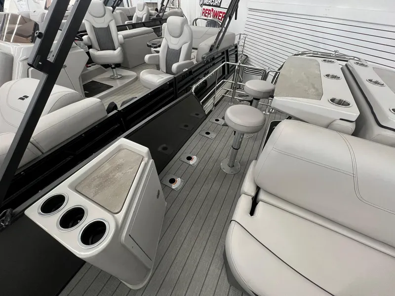 Slide: The Image of 2023 Starcraft CX 25 DL BAR boat interior with plush seating and modern amenities. - 12