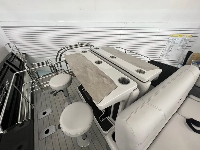 Slide: The Image of 2023 Starcraft CX 25 DL BAR interior with bar stools and cup holders. - 13