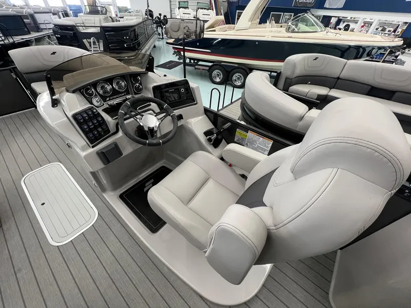 Slide: The Image of 2023 Starcraft CX 25 DL BAR boat interior with modern helm and plush seating. - 8