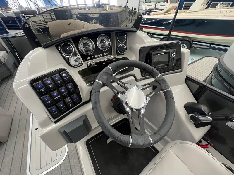 Slide: The Image of 2023 Starcraft CX 25 DL BAR boat dashboard with steering wheel and control panel. - 9