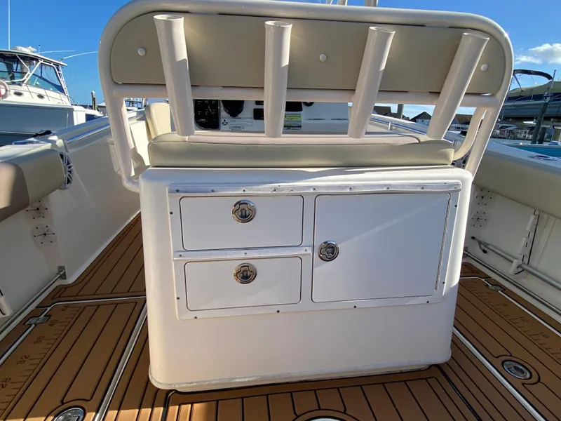 Slide: The Image of 2018 Cobia 237 CC boat interior with storage compartments and cushioned seating. - 13