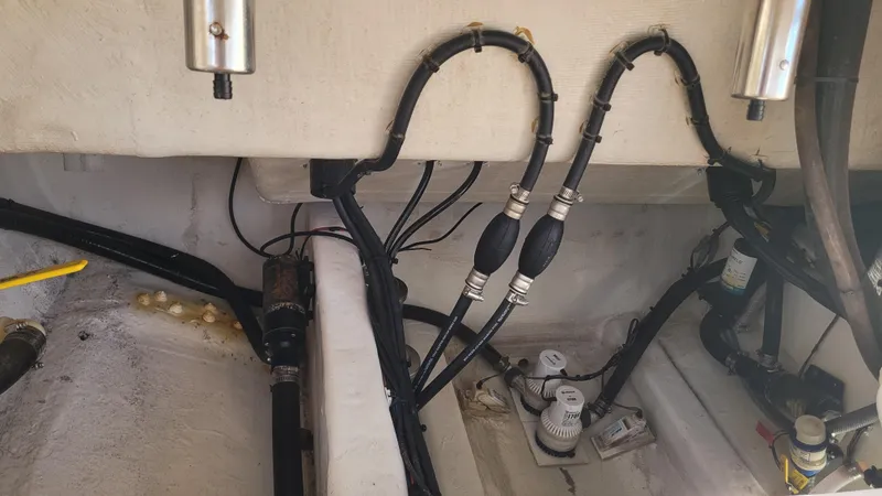 Slide: The Image of 2018 Cobia 237 CC boat wiring and pump system in the hull. - 15