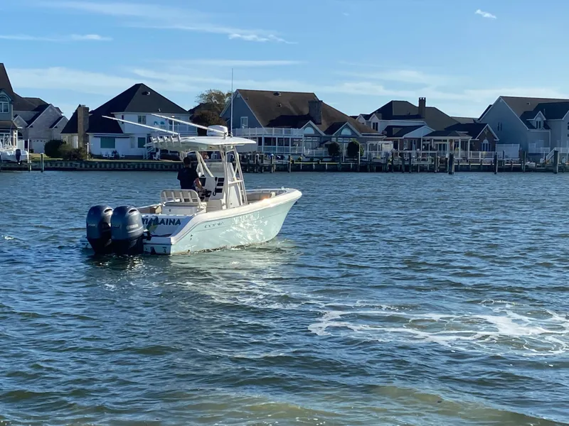 Slide: The Image of 2018 Cobia 237 CC boat on water near waterfront homes. - 6