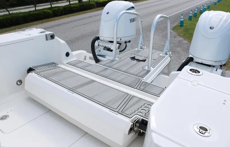 Slide: The Image of 2025 World Cat 260 CC-X boat with dual Yamaha engines and swim platform. - 16